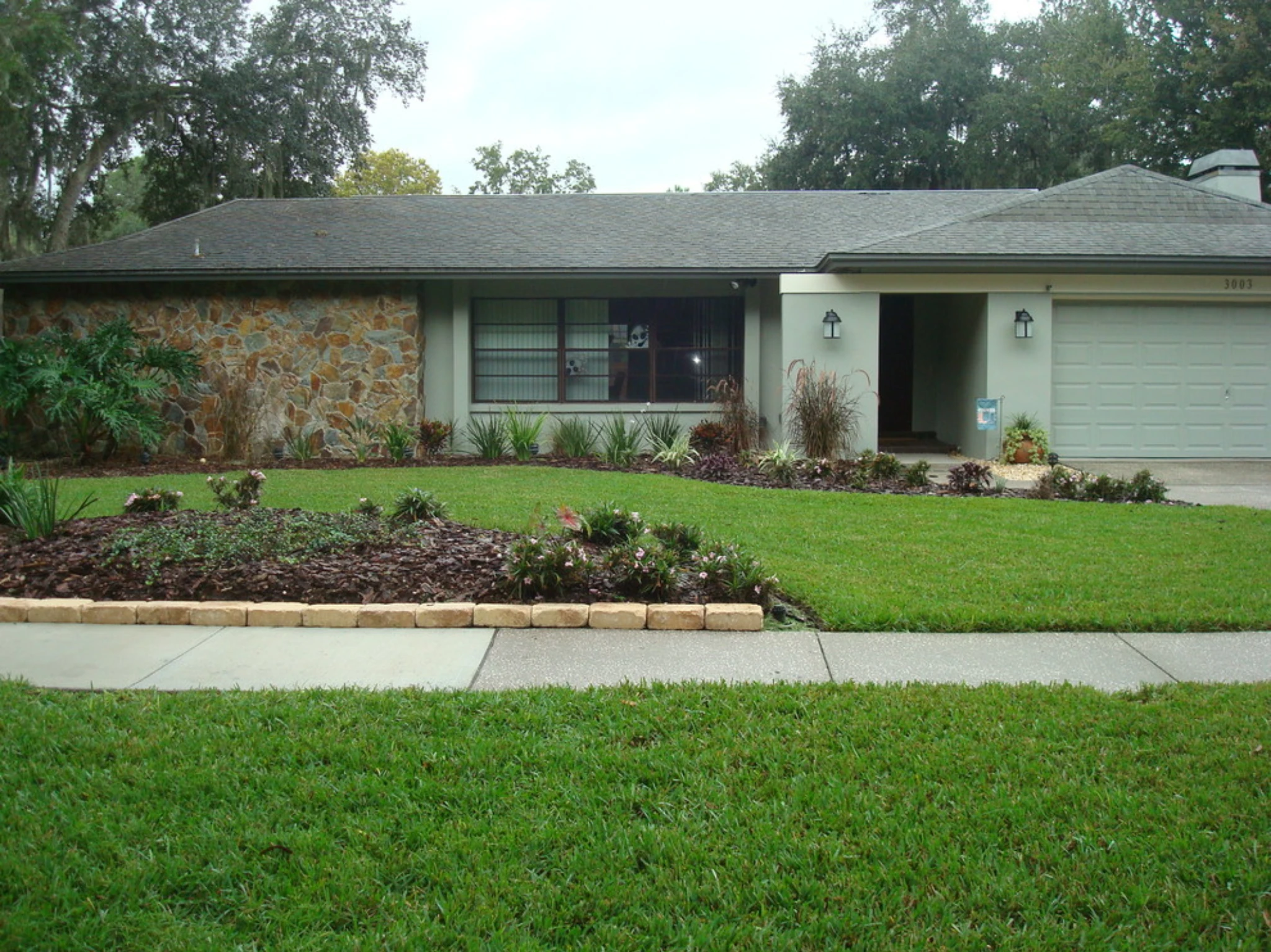 Single-story ranch-style home exterior in Florida suburban neighborhood with landscaped yard