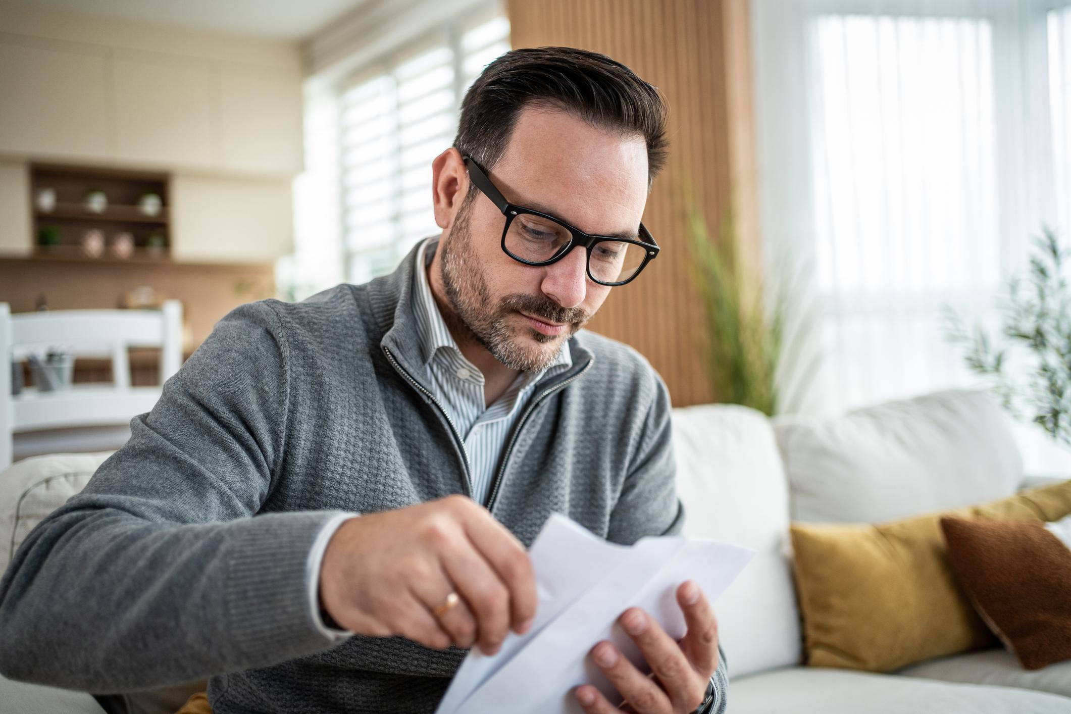 Homeowner reviewing delinquent property tax paperwork